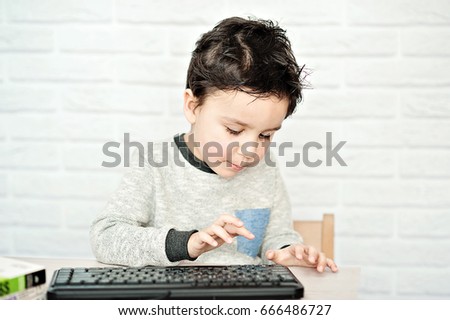 Concept of little businessman, webmaster, programmer, developer, Website designer. Little child and laptop, computer notebook