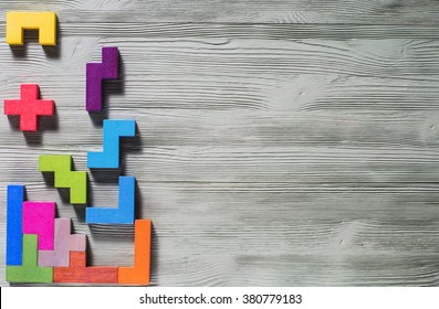 The Concept Of Logical Thinking. Geometric Shapes On A Wooden Background. 
Tetris Toy Wooden Blocks.