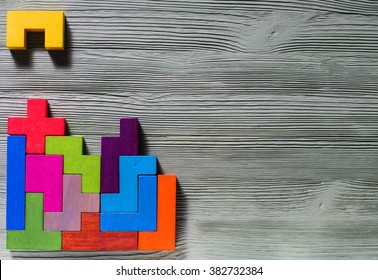 The Concept Of Logical Thinking. Geometric Shapes On A Wooden Background. 
Tetris Toy Wooden Blocks.