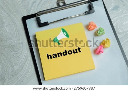 Concept of loudspeaker and handout write on sticky notes isolated on Wooden Table.