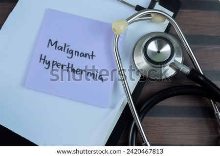 Concept of Malignant Hyperthermia write on sticky notes with stethoscope isolated on Wooden Table.