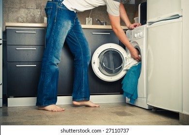 Concept Man Putting His Laundry Into The Washing Machine