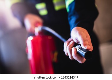 Concept man using fire extinguisher fighting fire closeup