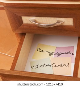 concept of management - paper reminder  in open desk drawer