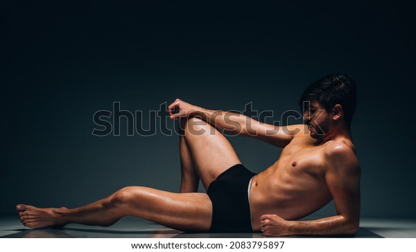 Concept of man\'s health\
and vitility.Photo of man\'s flat sporty abdomen, he is wearing\
black tight underwear