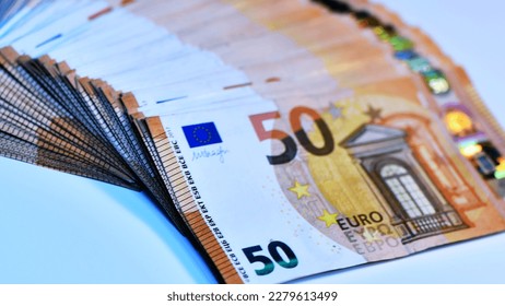 Concept of many euros: a pile of 50-euro bills lying on a white background. Many 50 € bills isolated on white background. concept of inflation and economy europe area