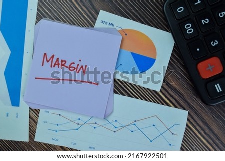 Concept of Margin write on sticky notes isolated on Wooden Table.