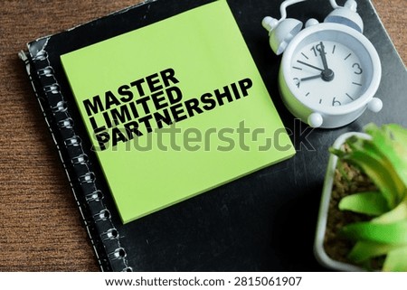 Concept of master limited partnership write on sticky notes isolated on Wooden Table.