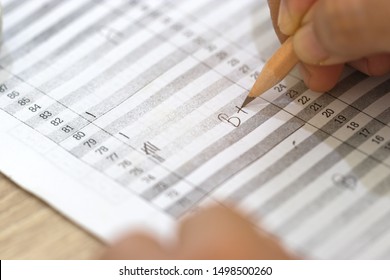 Concept Of Measurement And Evaluation. Hand Of Teacher Using Pencil Written Text On Paper Of Final Grades For Each Course. The Number Of Grade Points Student Earned In Given Period Of Time Of School. 