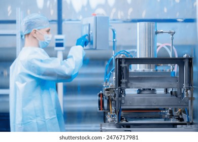 Concept med industry on medicine factory. Worker use control panel of automatic machine production line for manufacture of medical plastic form for surgical kit. - Powered by Shutterstock