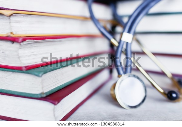 The concept of medical education.
Collection of scientific papers in a multicolored multi-volume with
a stethoscope. Preparing a Medical Student for an
Exam