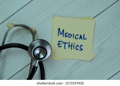 Concept of Medical Ethics write on sticky notes isolated on Wooden Table.