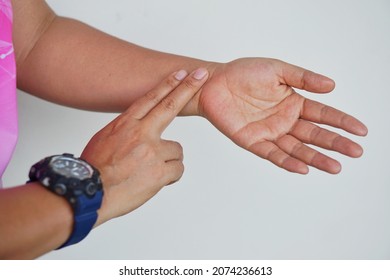 Concept : Medical, Health Care. Pulse Measurement. Self Taking Care At Home. Woman Uses Two Fingers To Touch Her Wrist To Check Pulse.