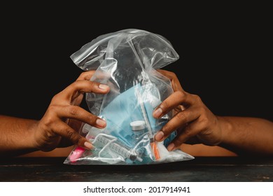 Concept Of Medical Waste Clear Plastic Bags Containing Masks, Gloves, And Vaccine Bottles Are Trash After Use.
