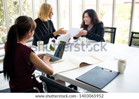 Concept of meeting room where staff are planning and looking for ways to do business. Employees propose work plans at the meeting. Female employees are presenting work to supervisor at the meeting.