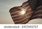 Concept of Memorial Day, Remember and Honor, 4th of July, Independence Day, Veteran Day, Holiday, Celebration. American USA flag waving in sunset outdoor background for honoring, mourning USA military
