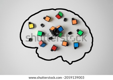 Concept of mental health. Silhouette of a human brain with a broken conundrum on a gray background. 