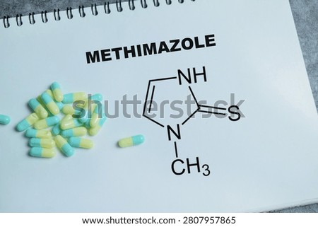 Concept of methimazole antithyroid write on book isolated on Wooden Table. For hypertension treatment and thyroid hormone regulation