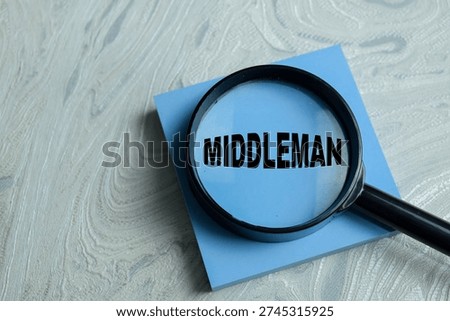 Concept of middleman write on sticky notes isolated on Wooden Table. For investigating intermediaries, supply chain and business analysis