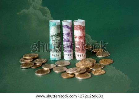 Concept of minimum wage increase with rolled-up banknotes and coins on a green background. Colombia