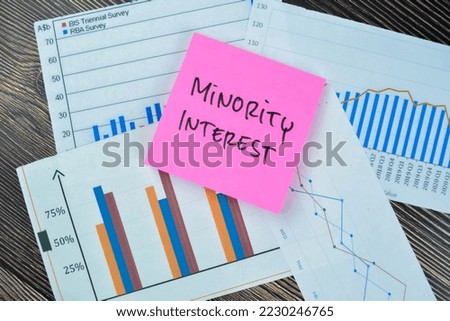Concept of Minority Interest write on sticky notes isolated on Wooden Table.