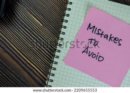 Concept of Mistakes to Avoid write on sticky notes isolated on Wooden Table.