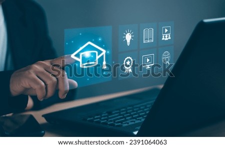 Concept of modern educational technology learning curriculum ,Human hand taps graduation cap icon to enter internet website to learn the educational curriculum to develop,skills with virtual screen.