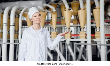 Concept Modern Food Industrial. Operator Worker Woman On Background Electrical Mill Machinery For Production Of Wheat Flour.