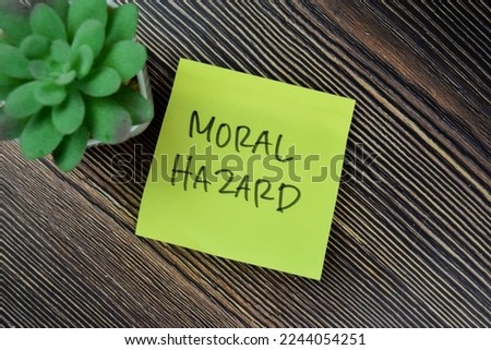 Concept of Moral Hazard write on sticky notes isolated on Wooden Table.