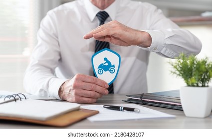 Concept of motorbike insurance with paper shield protected by hand of insurer - Shutterstock ID 2180428107