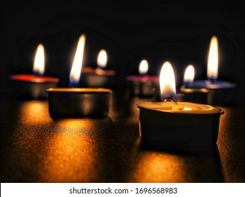 concept of mourning the dead from the corona virus represented by warm candles.COVID-19    