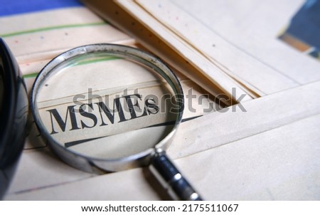 Concept of MSME or Micro, Small and Medium Enterprises searching with magnifying glass.