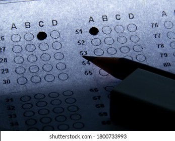 Concept Of Multiple Choice Question With Pencil Eraser And Paper.