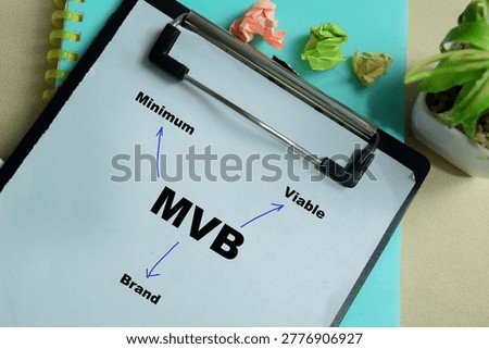 Concept of MVB - Minimum Viable Brand write on clipboard isolated on Wooden Table.