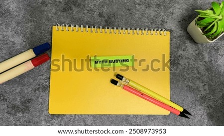 Concept of Myth Busting write on sticky notes isolated on Wooden Table.