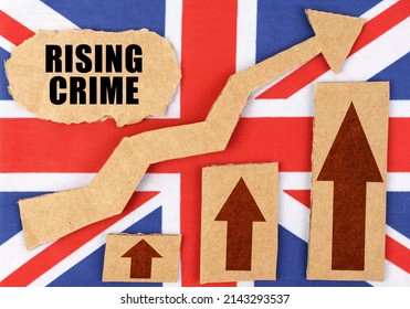 The Concept Of National Statistics. On The Flag Of Great Britain, A Growth Chart And A Cardboard Plate With The Inscription - Rising Crime