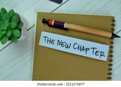 Concept Of The New Chapter Write On Sticky Notes Isolated On Wooden Table.