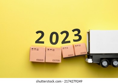 The concept of the new year 2023. Loading goods into a truck van. - Shutterstock ID 2174279249