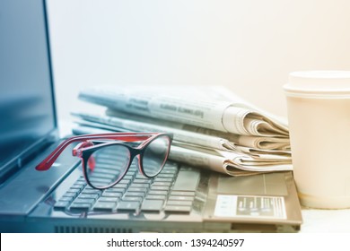 The Concept Of News. Newspaper, Laptop, Glasses On Your Desktop Coffee Break.