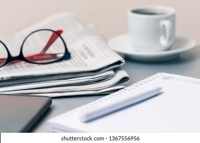 The concept of news. Newspaper on the table, glasses. Coffee break. - Shutterstock ID 1367556956