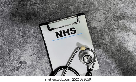 Concept of NHS write on paperwork isolated on wooden background.