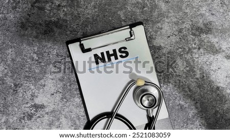 Concept of NHS write on paperwork isolated on wooden background.