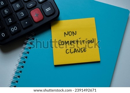 Concept of Non Competition Clause write on sticky notes isolated on Wooden Table.