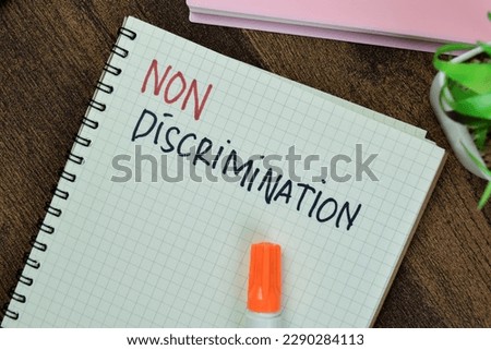 Concept of Non Discrimination write on book isolated on Wooden Table.