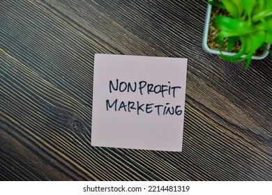 Concept Of Nonprofit Marketing Write On Sticky Notes Isolated On Wooden Table.