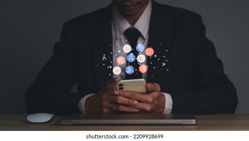 The Concept With Notification Icons Of Like Being Happy And Social Media Interactions On Mobile Phones, Messages, Email, Comments, Businessman Hands Holding Devices, Smartphones, And Digital Internet Marketing.