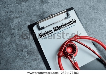 Concept of nuclear mitochondria write on clipboard isolated on Wooden Table.