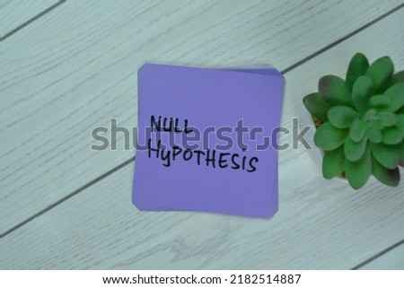 Concept of Null Hypothesis write on sticky notes isolated on Wooden Table.