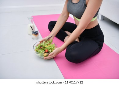 The Concept Of Nutritional Food. Beautiful Girl Takes Care Of Her Health By Eating Vegetables. Young Athlete Choose A Good Diet.