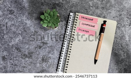 Concept of Obsessive Compulsive write on sticky notes isolated on Wooden Table.